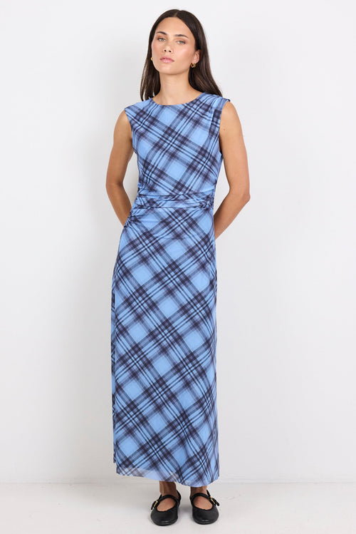 Woman wearing a blue plaid dress against a white background