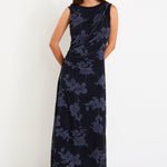 Model wearing a sleeveless midnight floral mesh maxi dress with gentle gathering at the waist and a slim, draped silhouette.