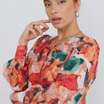 model wears a orange floral top