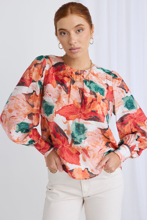 model wears a orange floral top