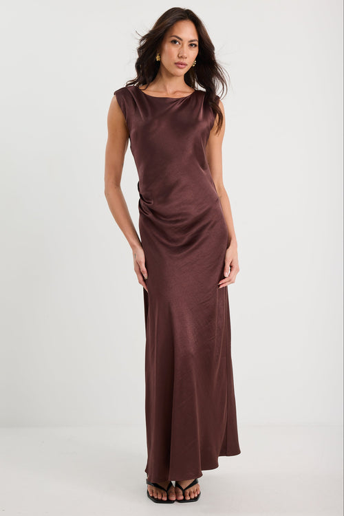 Woman wearing a brown evening gown on a white background