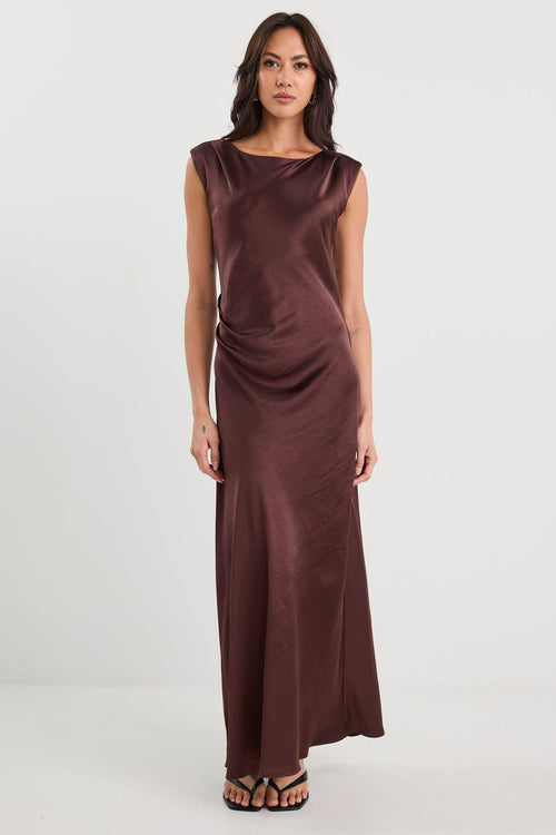 Woman wearing a brown evening gown on a white background