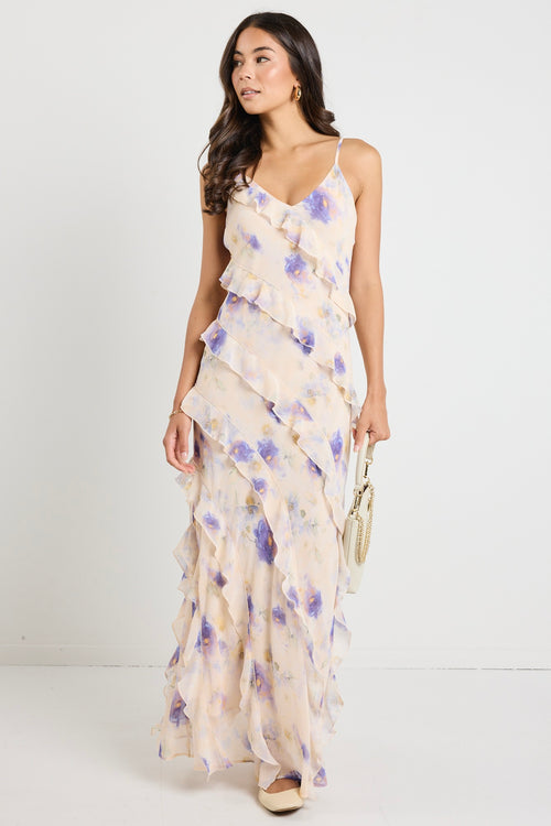 Model wears a floral cream maxi dress