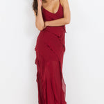Woman wearing a red dress against a white background