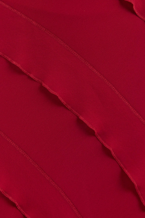 Close-up of a red dress with layered fabric