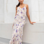 Model wears a floral cream maxi dress