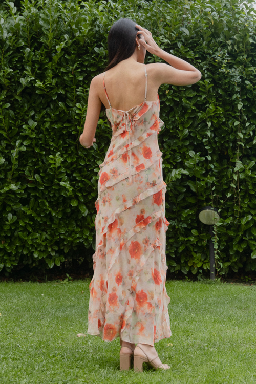 model wears orange ruffled slip dress