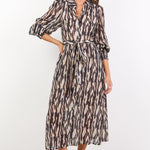 Woman wearing a patterned dress on a white background