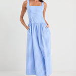 Woman wearing a blue striped dress on a white background