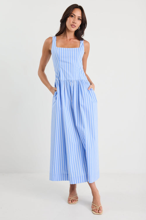 Woman wearing a blue striped dress on a white background