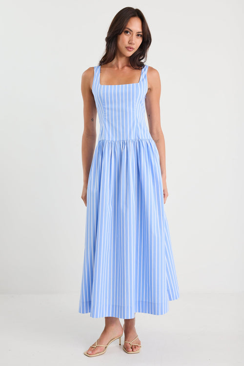 Woman wearing a blue and white striped dress on a white background