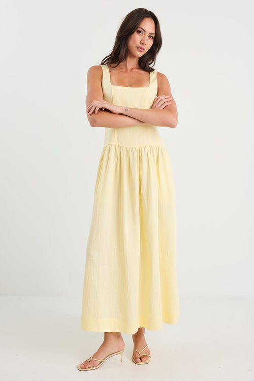 Woman wearing a yellow dress against a white background