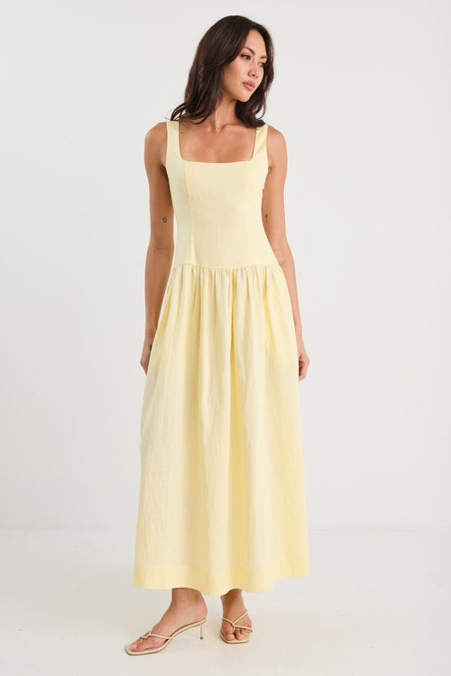 Woman wearing a yellow dress on a white background