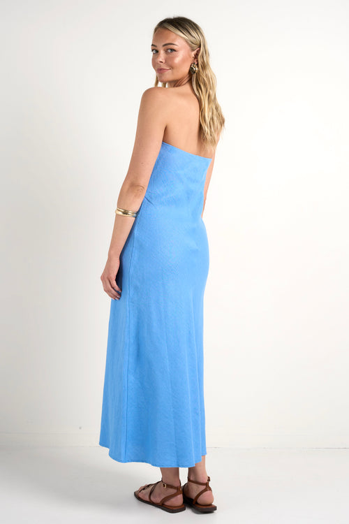 model wears blue strapless maxi dress