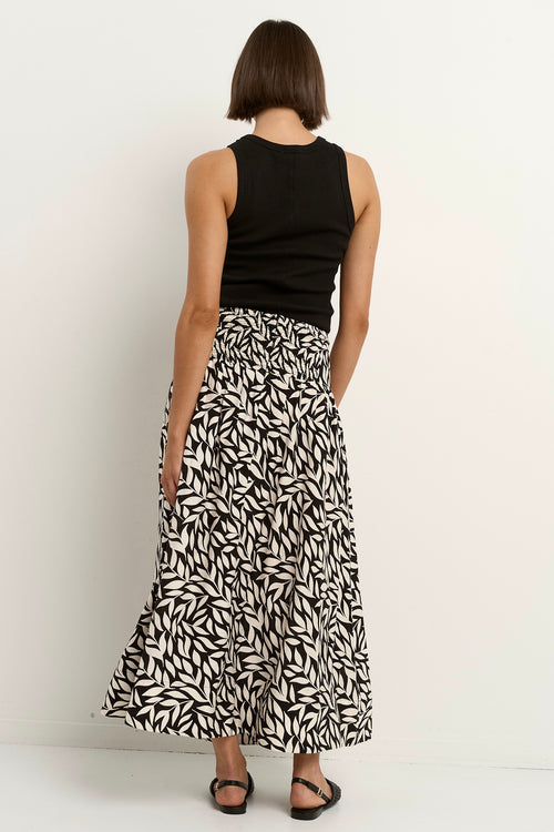 our model wears a black and white floral print maxi skirt with a black tank