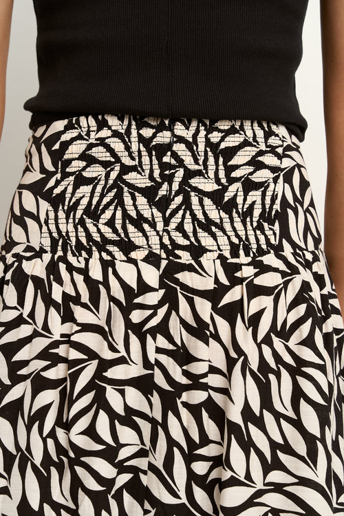 our model wears a black and white floral print maxi skirt with a black tank