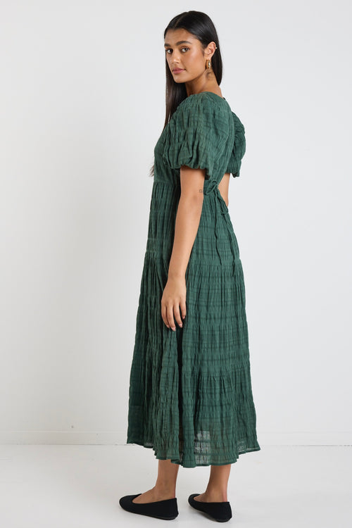 Model wears a forest green maxi dress