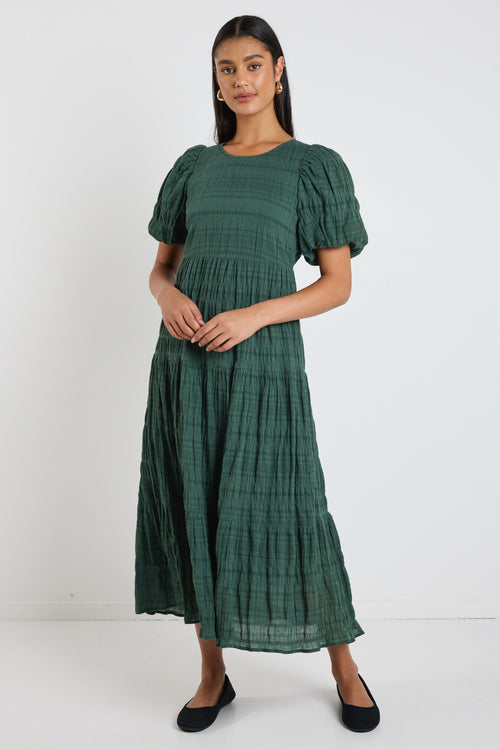 Model wears a forest green maxi dress