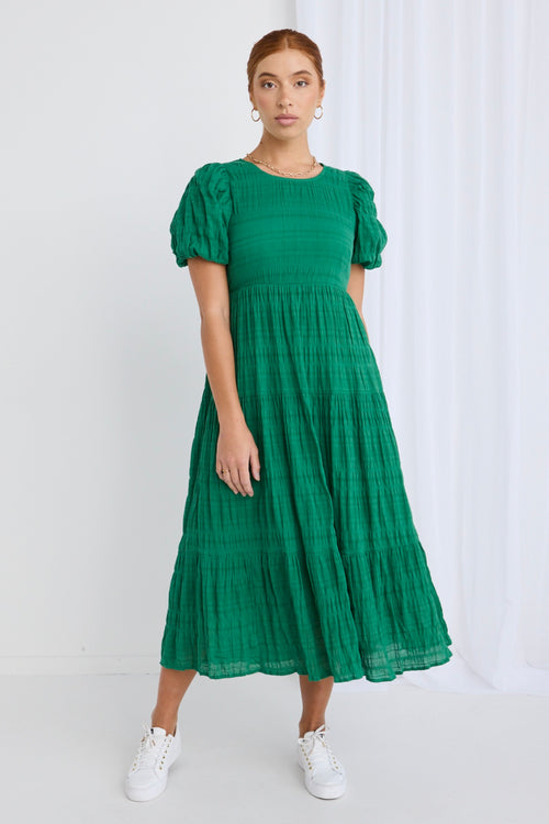 model wears a green maxi dress