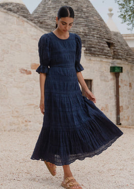 model wears a dark blue maxi dress