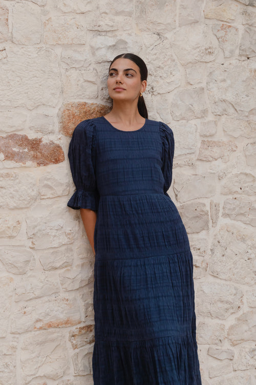 model wears a dark blue maxi dress