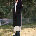 model wears a black coat