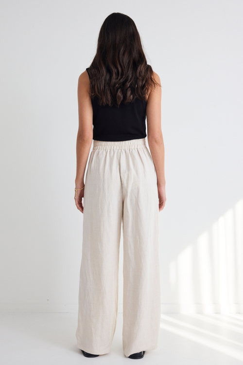 model wears Natural Linen Wide Leg Pants and a black tank top