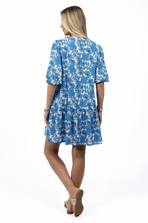 Woman wears a blue white mini smock dress