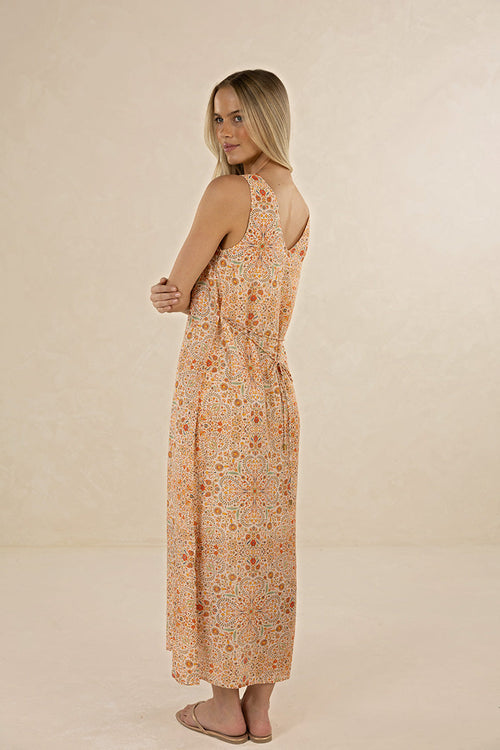 Woman wearing a floral dress against a beige background