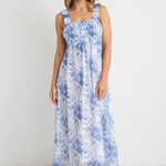 model wears a blue floral maxi dress