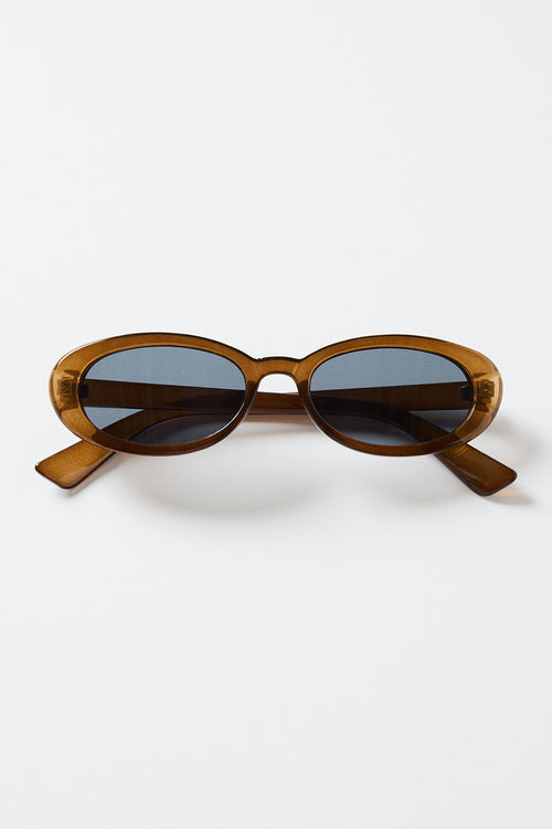 Slim oval sunglasses with a translucent espresso-brown frame and dark tinted lenses, photographed on a white background
