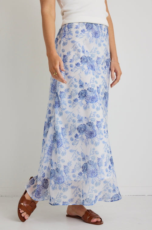 model wears a blue floral maxi skirt