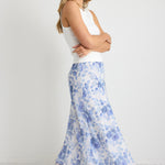 model wears a blue floral maxi skirt