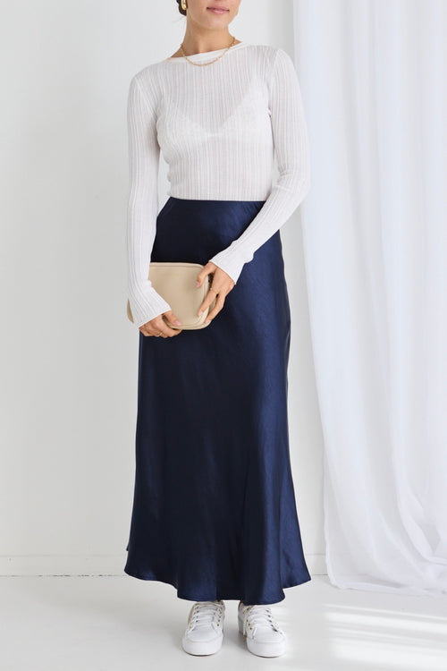 model wears a navy maxi skirt