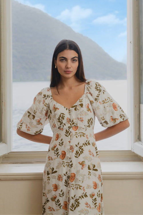 model wears floral white Midi dress