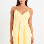 Woman wears a yellow mini dress with v-neck
