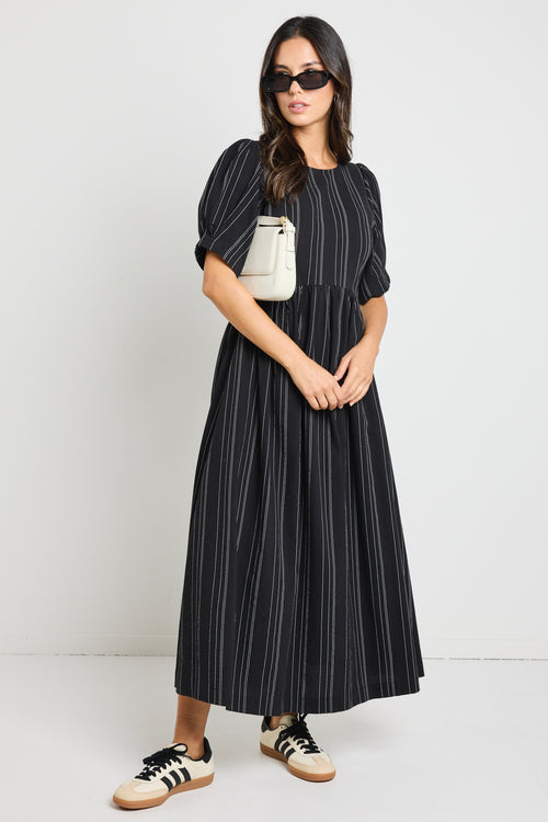 Model wears a black stripe maxi dress with short sleeves