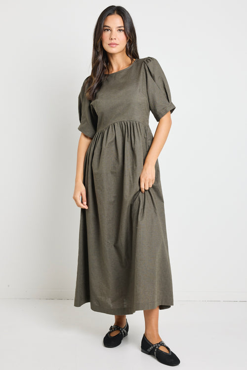 Model wears a khaki midi dress with rounded neckline