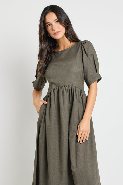 Model wears a khaki midi dress with rounded neckline