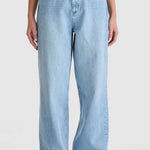 light blue high-rise wide leg jeans with patch pockets and leather logo patch on waistband. Model wears them full length with relaxed fit through the legs.