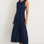 Woman wearing a navy blue dress against a white background