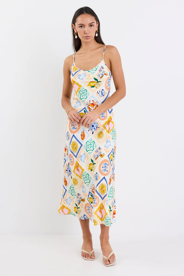 Model wearing a Bias Slip Dress in a vibrant, tropical print.