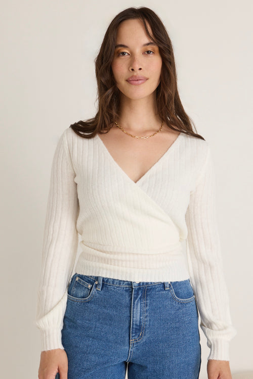 model wears a white knit 