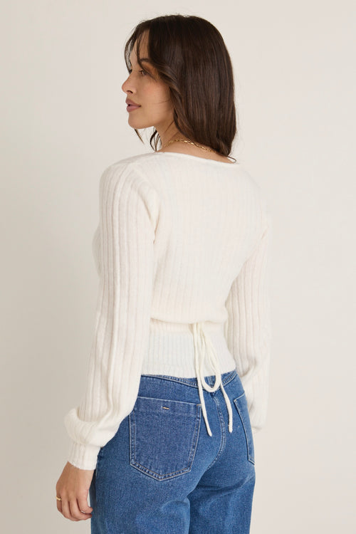 model wears a white knit 