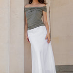 Woman standing against a classical building with columns