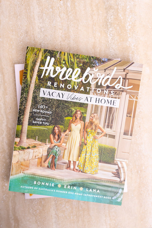 Book titled 'How to Renovate Your Vacay Home' on a wooden surface