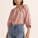 model wears a pink linen blouse