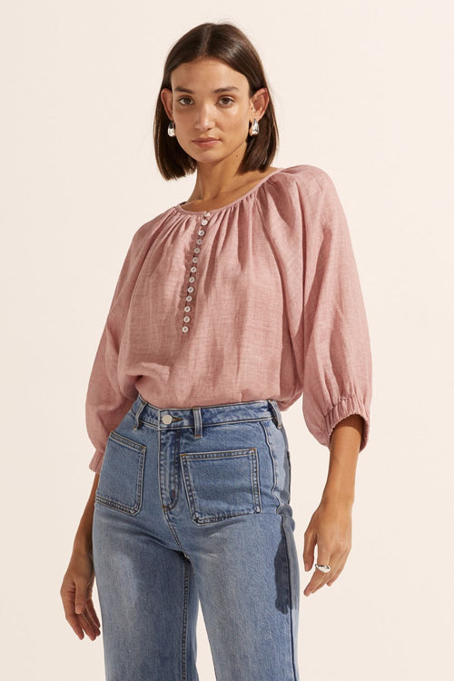 model wears a pink linen blouse