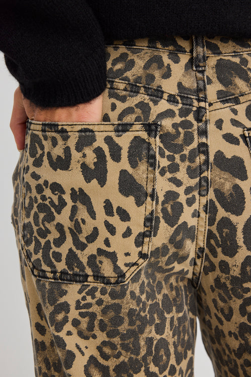 model wears a black cardigan with leopard print jeans