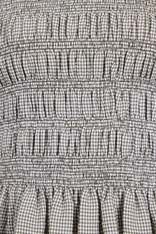 Close-up of a checkered fabric with smocked waistband
